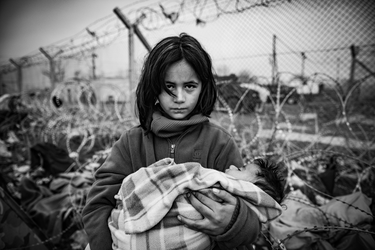 The refugee camp in Idomeni on the Greek-Macedonian border, to which thousands of immigrants, mainly Syrians, are coming. It is occupied by people from different social strata. They are all found there fleeing the war, death and starvation. They continue their journey through Macedonia to the north and west of Europe. Not everyone manages to pass the verification of the documents, which leads to the separation of families. The refugees are living in difficult conditions and sleeping in overcrowded and soaked tents. They are frozen and have limited access to sanitation. The refugees are exhausted, tired and uncertain about their situation.